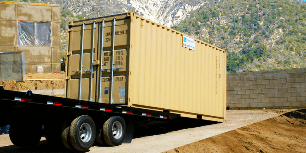 storage container on a truck being lowered onto the ground