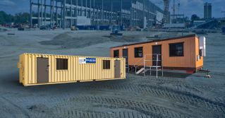 Shipping container and office trailer on construction site