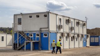 Shipping containers being used as offices at construction sites.png