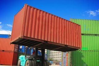 A forklift lifting a cargo box